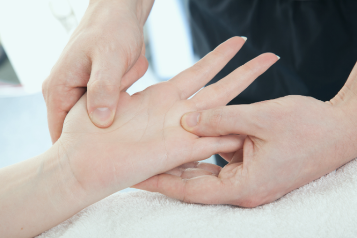 Hand surgeon assessing patient for thumb osteoarthritis